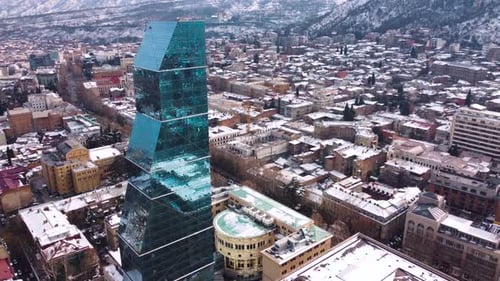 Glass Skyscraper In The Snowy City