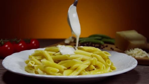 Creamy White Sauce Poured on Penne Pasta