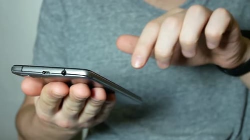 Man Uses A Modern Smartphone