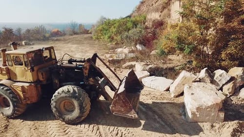 Professional Bulldozer With a Bucket is Picking Stones