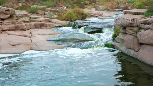 A Small Shining Stream Flows Among Smooth Wet and Dark Stones