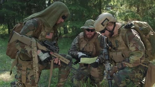 US Soldiers Looking At Map Of Area