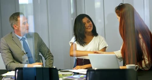 Three Colleagues Meet in a Modern Office