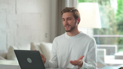 Young Adult Participates in Virtual Meeting at Home