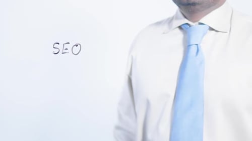 Man Writes "SEO" on Invisible Clear Surface