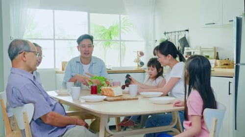 Family Gathered Around Table Enjoying Breakfast Together