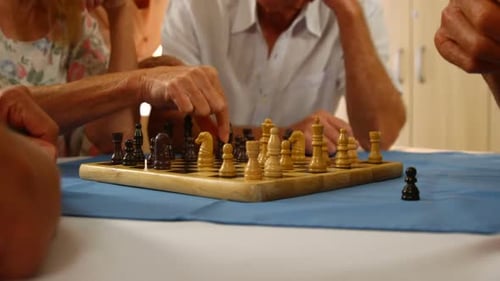Senior Adults Playing Chess Together Indoors
