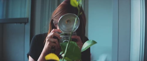 Woman photographer taking a picture of exotic plant