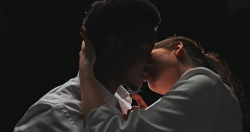 Intimate Couple Embrace and Kiss in Soft Light