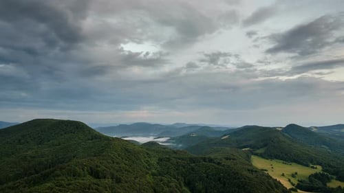 Dramatic Clouds over Green Forest Landscape