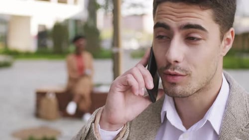 Young Adult Man Talking on Phone in City