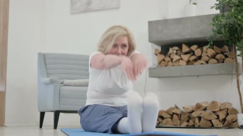 Senior Woman Stretching Arms On Yoga Mat