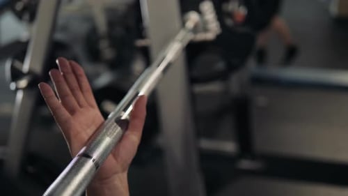 Closeup of a Strong Man's Hands with Talc Getting Ready to Weightlifting at the Garage Gym