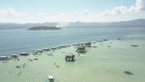 Top View of a Resort with Deep and Shallow Sea, Islands, Bungalows and Boats.