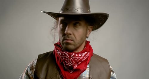 Man Dressed as Cowboy Looks Around
