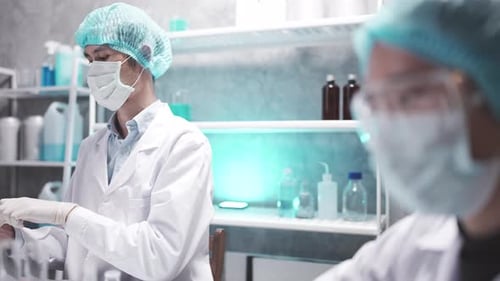 Scientists Wearing Masks Working in Medical Lab