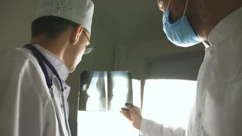 Two Caucasian Doctors View Mri Picture and Discussing About It