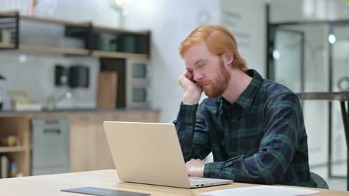 Red-Haired Man Wakes Up at Office Desk