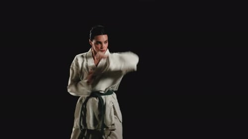 Woman Performing Karate Moves in a Studio