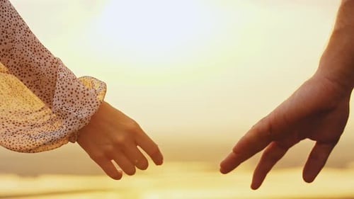 Couple Holding Hands at Romantic Sunset Beach