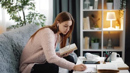 Woman Reading and Taking Notes at Home