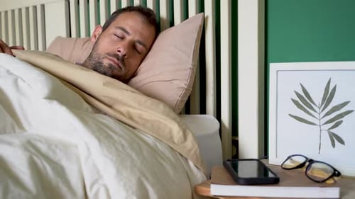 Man Sleeping Peacefully in Bed at Home