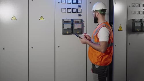 Specialist of Electrical Engineering Service is Checking Meter Reading on Electric Panel