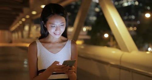 Woman use of mobile phone at night