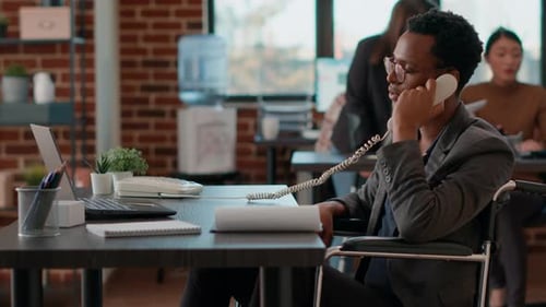 Company Employee Answering Landline Phone Call in Office