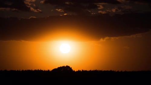 Golden Sunset with Clouds over Natural Landscape