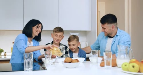 Happy Family Enjoying Breakfast Together at Home