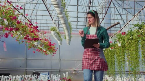 Une femme caucasienne a utilisé un cahier pour analyser et enregistrer les données des fleurs de couleur