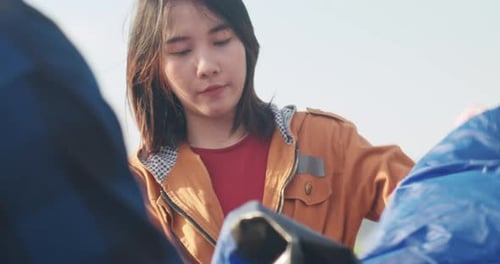 Friends Setting up Tent in Rural Setting