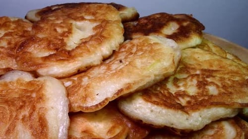 Stack of Fresh Fried Homemade Sweet Pancakes Rotating on Plate
