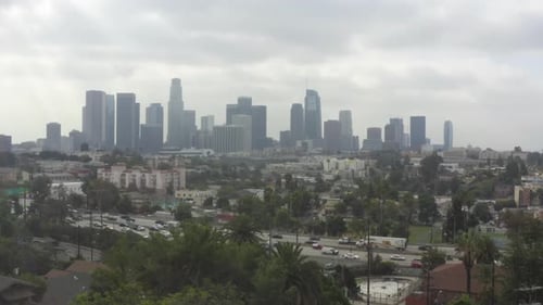 AERIAL: Echo Park Towards Downtown Los Angeles, California with Palm Trees and Highway, Cloudy