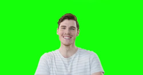 Caucasian man smiling at camera on green background