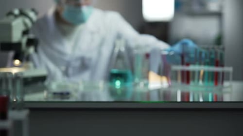 Laboratory Scientist Looking for Necessary Test Tube With Blood to Examine