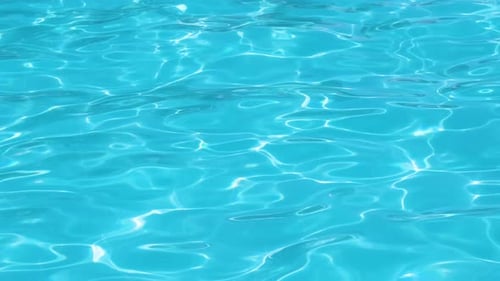 Closeup Surface of Blue Clear Water with Small Ripple Waves in Swimming Pool