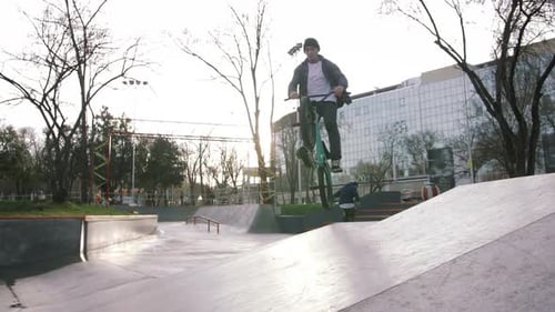 BMX Rider Doing Tricks in Street Plaza Bicycle Stunt Rider in Cocncrete Skatepark Super Slow Motion