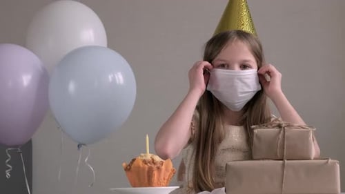 Girl Taking Off Protective Face Mask at Home on Birthday Party