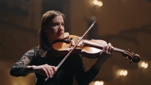 Female Musician is Playing Violin on Scene of Music Hall Portrait of Woman Violinist in Philharmonic