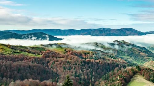 Landscapes of Green Hills Under a Layer of White and Fluffy Clouds