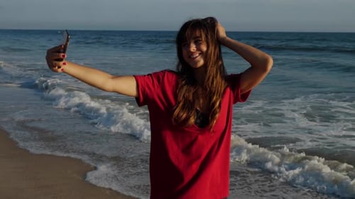 Attractive woman taking a selfie at the beach