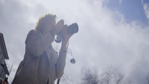 Young Adult Woman Photographs in City