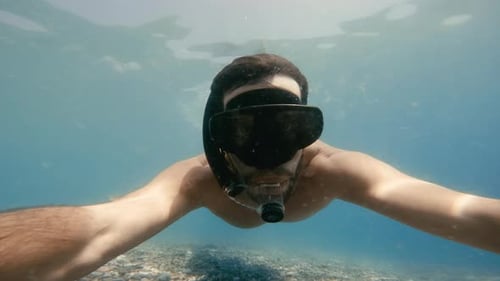 Man Snorkeling and Free Diving Underwater