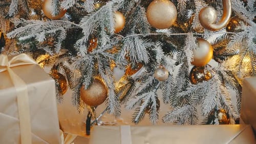 Gold Christmas Ornaments and Gifts Under Tree
