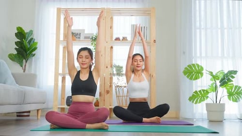 Women Practicing Yoga and Meditation at Home