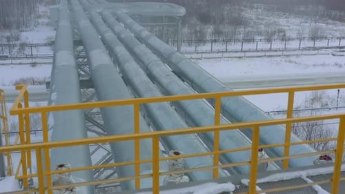 Pipelines Over Road at Gas and Oil Refinery Plant in Winter