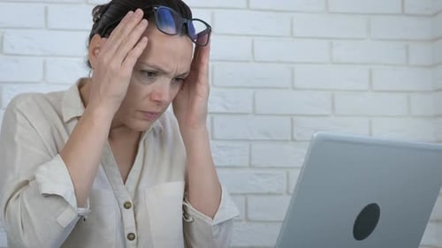 Checking bills on computer.