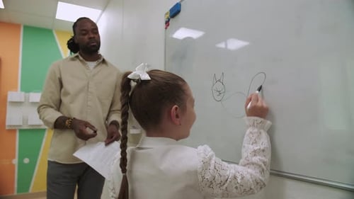 Girl Drawing Cat on Whiteboard in Classroom